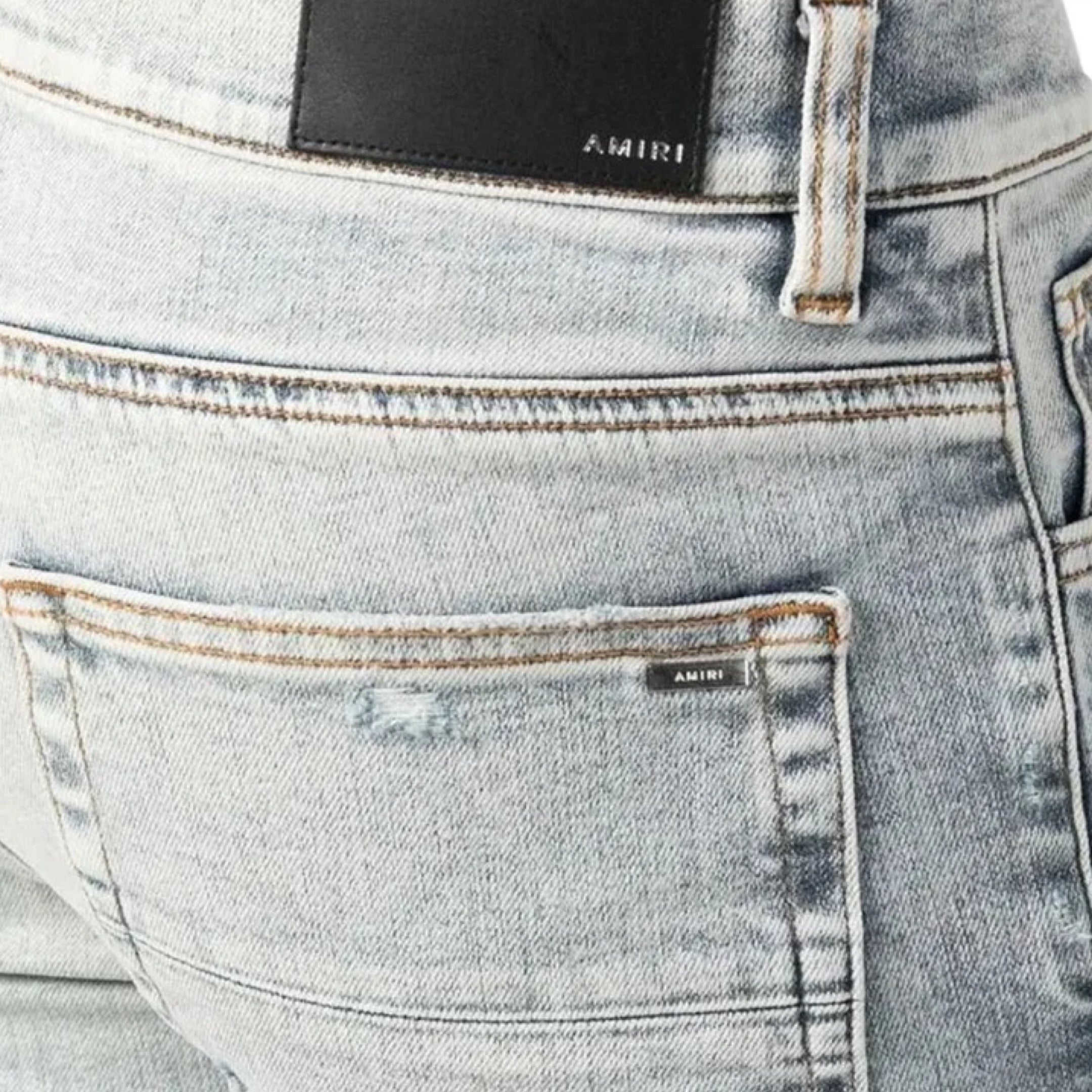 AMIRI MX1 STONE INDIGO WASHED RIPPED JEANS IN BLUE